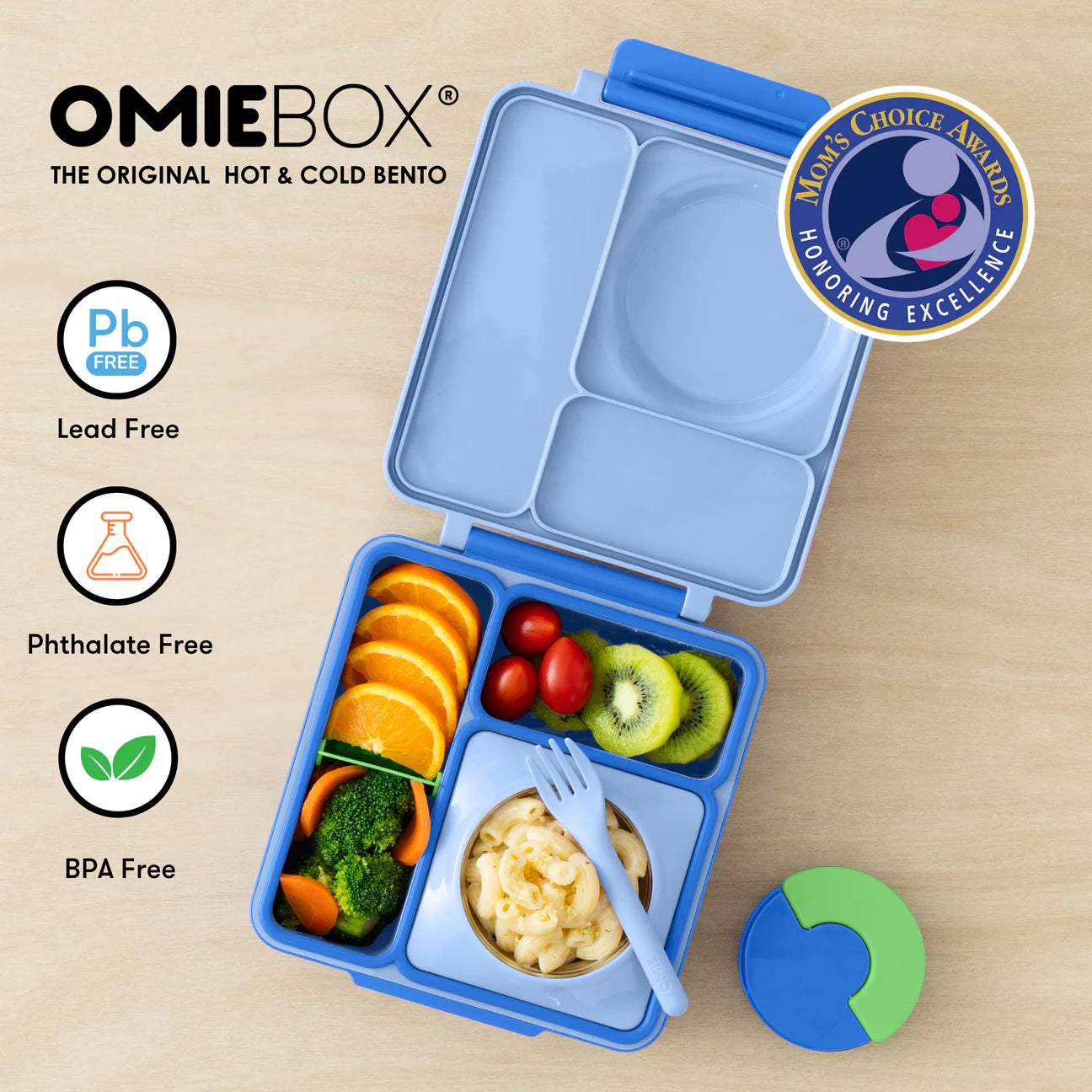 Pastel blue OmieBox lunch box for kids with compartments, thermos, and healthy food options like broccoli and fruit.