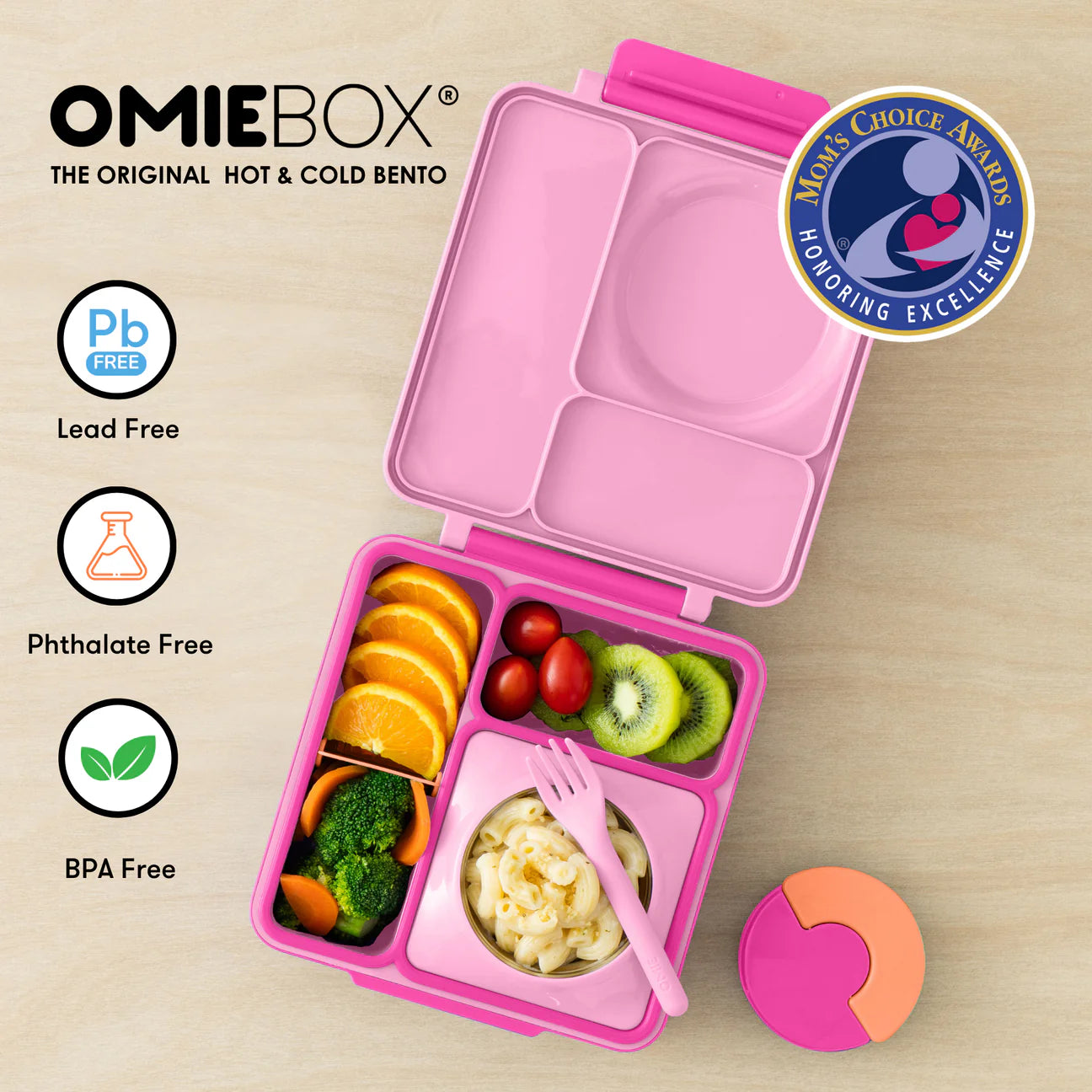 Pastel pink OmieBox lunch box for kids with compartments, thermos, and healthy food options.