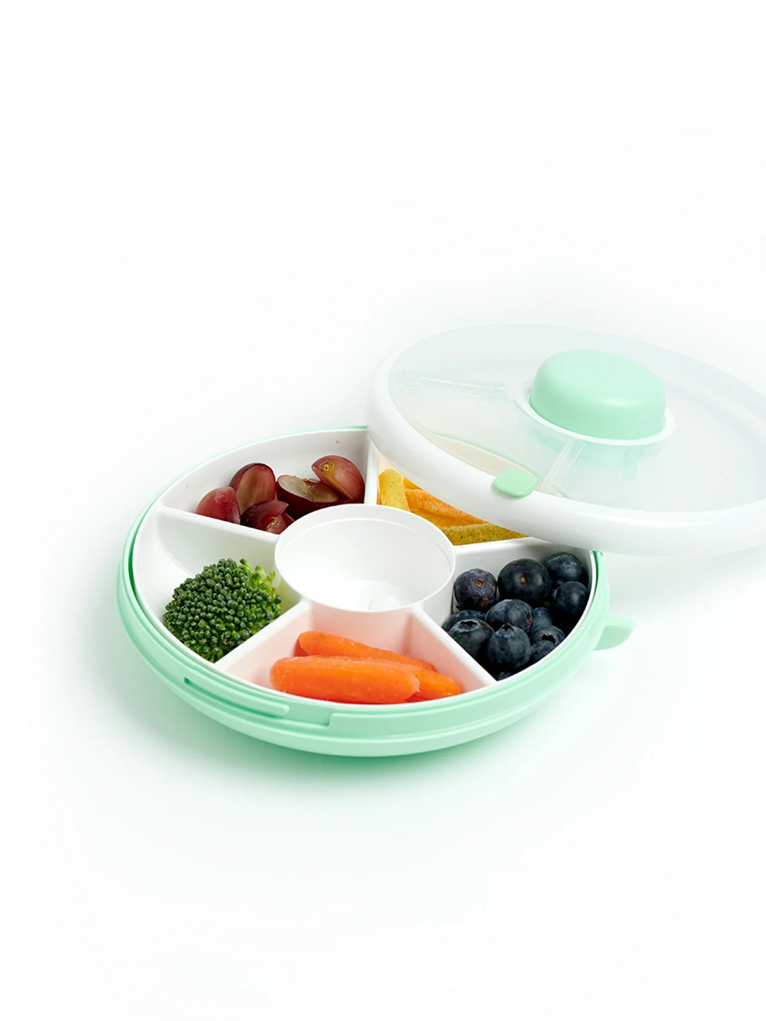 GoBe Snack Spinner lunchbox for kids in green, filled with grapes, carrots, blueberries, broccoli, and snacks.